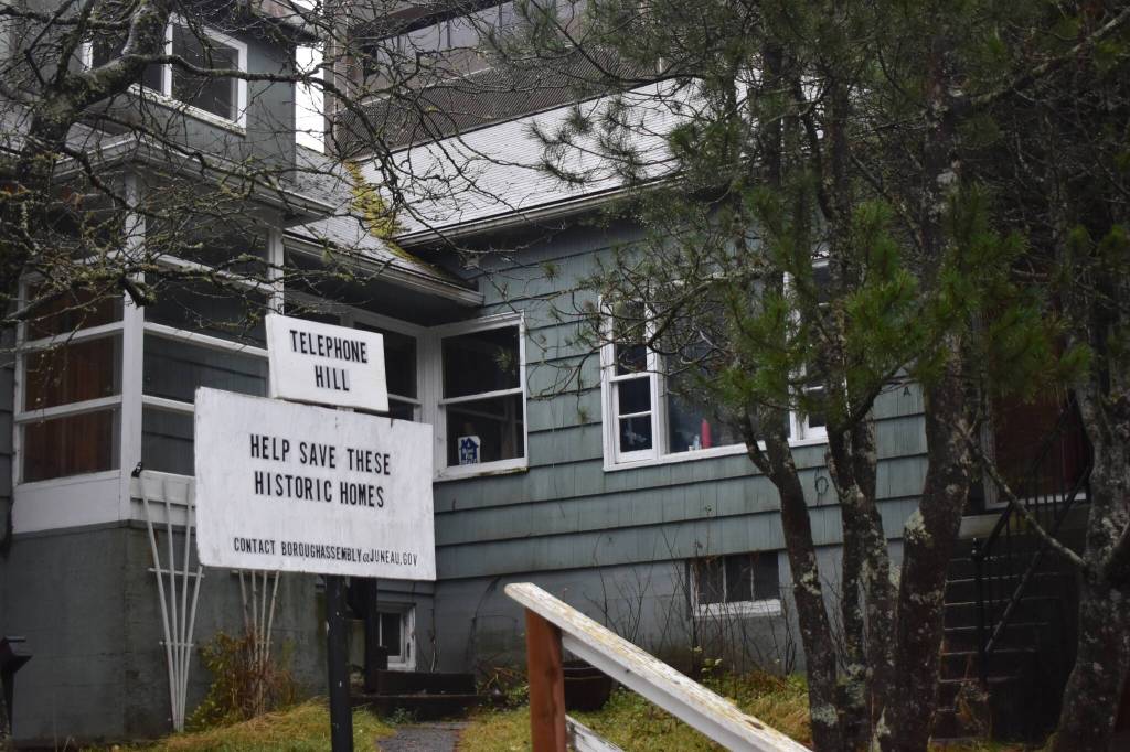 A sign reading, Help Save These Historic Homes is posted in front of a residence on Telephone Hill on Friday Nov. 21, 2025. (Mari Kanagy / Juneau Empire)