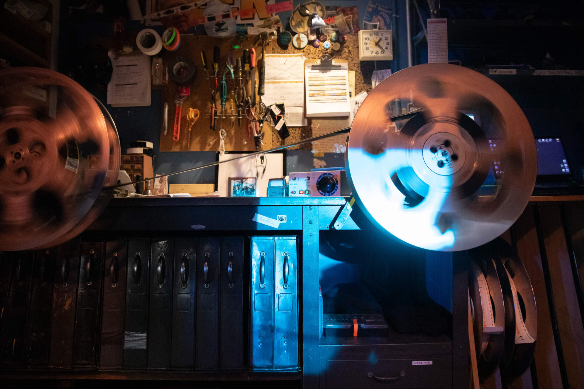 A 70 mm film reel for "The Testament of Ann Lee" is rewound after being used during a showing of the film at Coolidge Corner Theatre. (Artemisia Luk/WBUR)