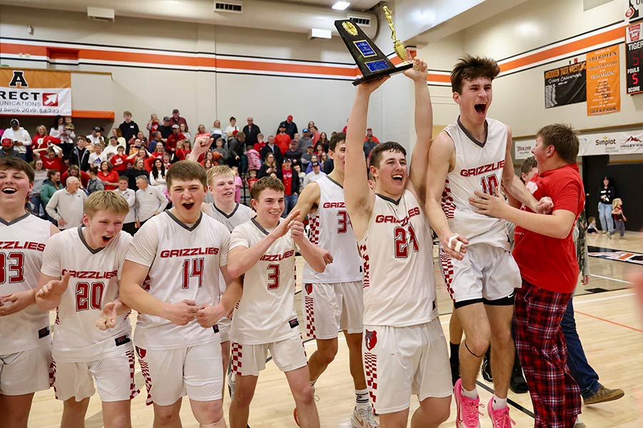 Bryson Anderson holds the trophy high as Grace celebrates