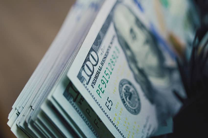 Cash counting machine counts hundred dollar bills