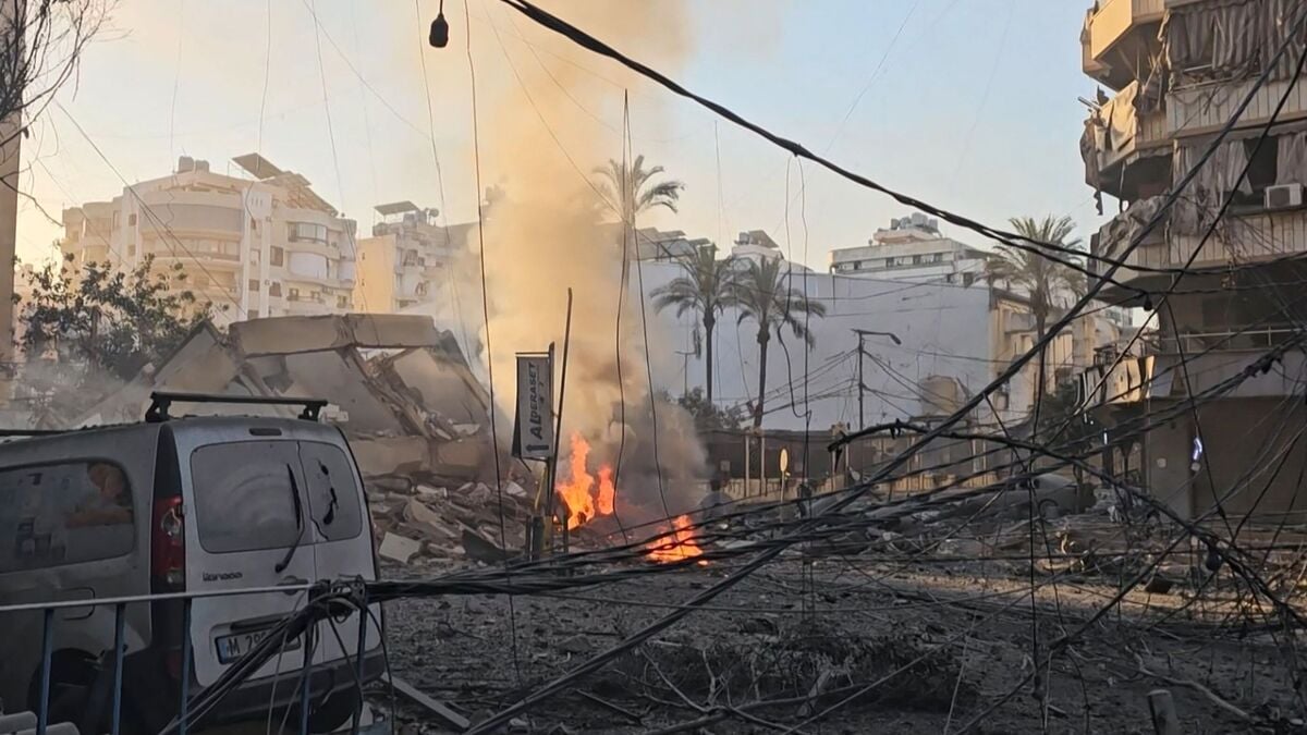 This frame grab from AFPTV video footage taken on March 3, 2026 shows smoke billowing from a fire and buildings damaged after an early morning Israeli strike on Beirut's southern suburbs.
