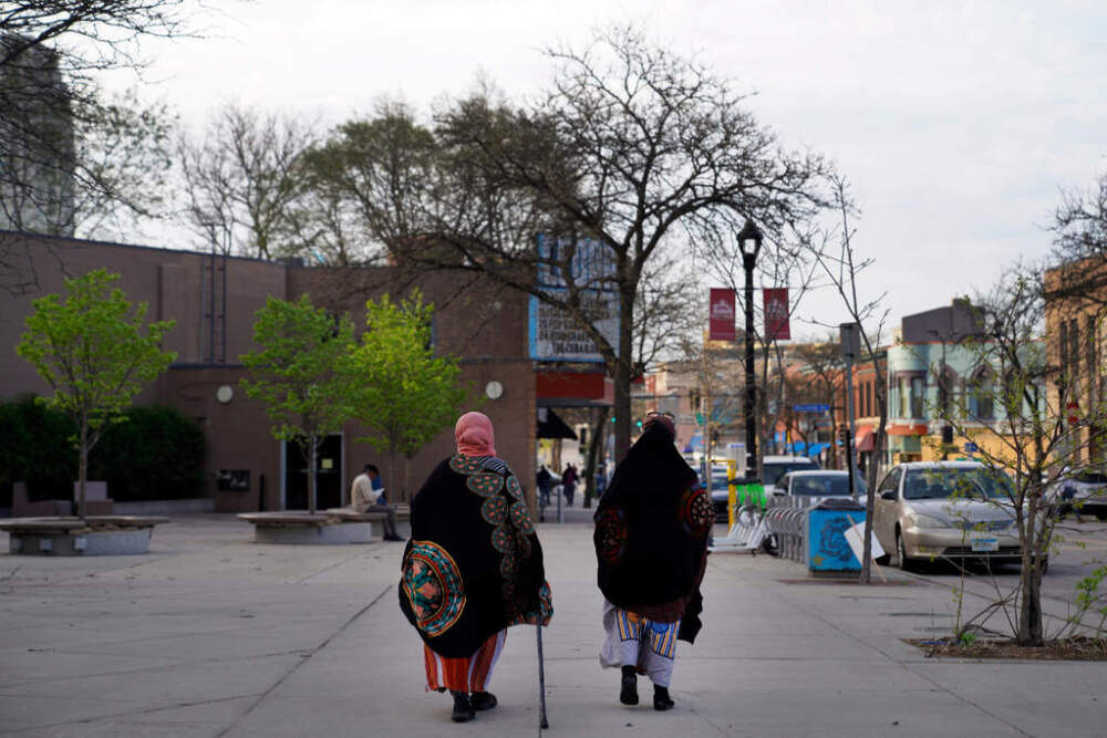 FILE - Women walk down a street in the predominantly Somali neighborhood of Cedar-Riverside in Minneapolis on May 12, 2022. (AP Photo/Jessie Wardarski, File)