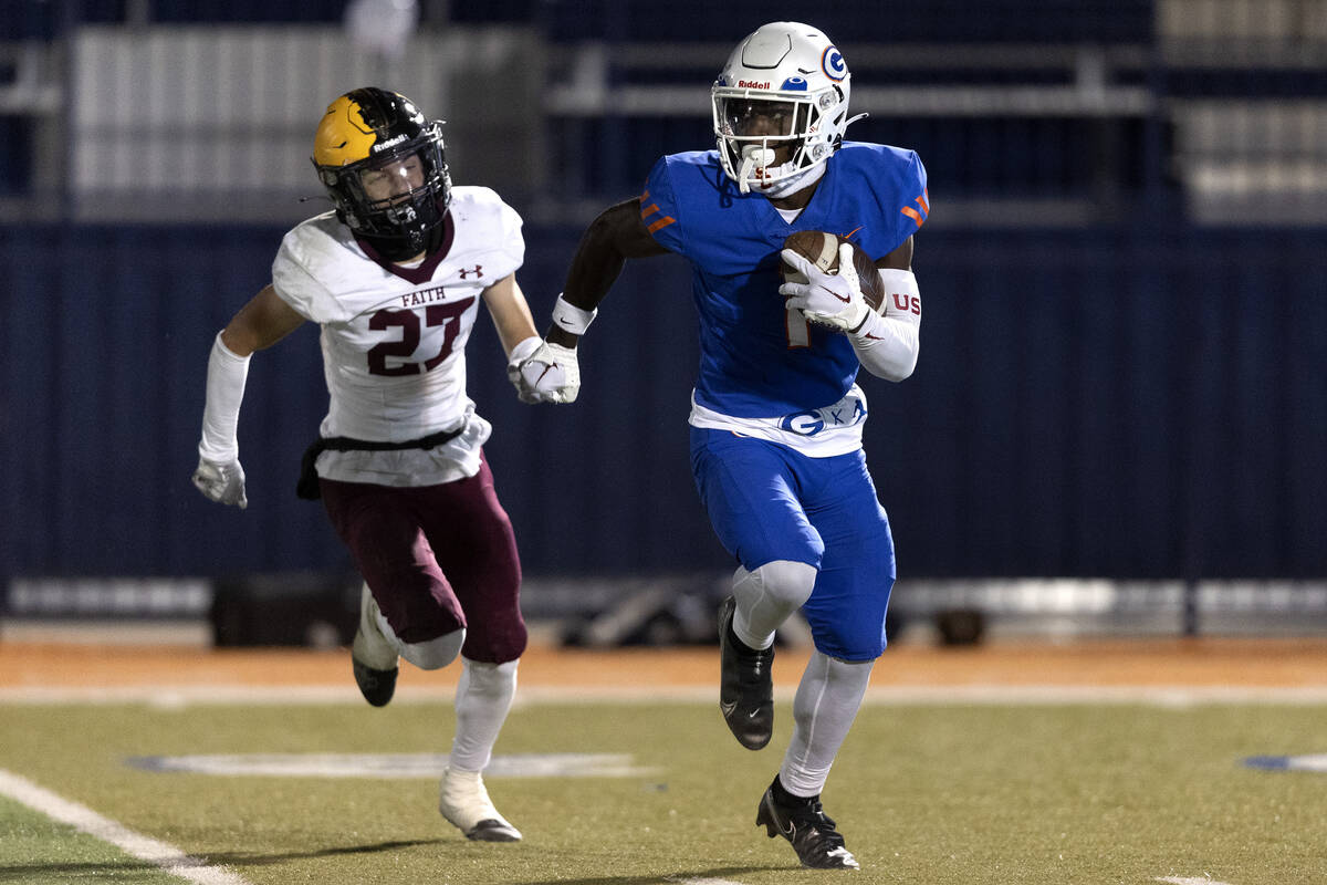 Bishop Gorman’s Zachariah Branch (1) breaks away with the ball before scoring a touchdow ...