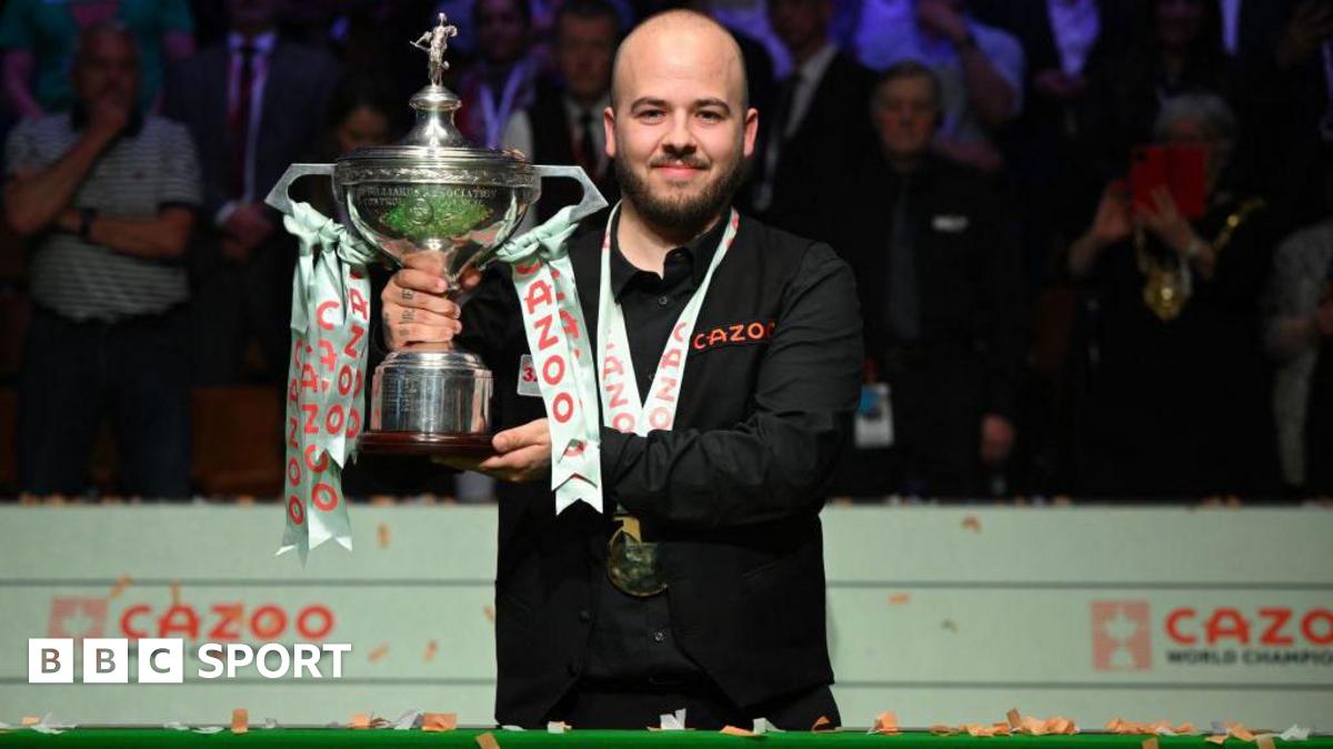 Luca Brecel holding the World Snooker Championship trophy