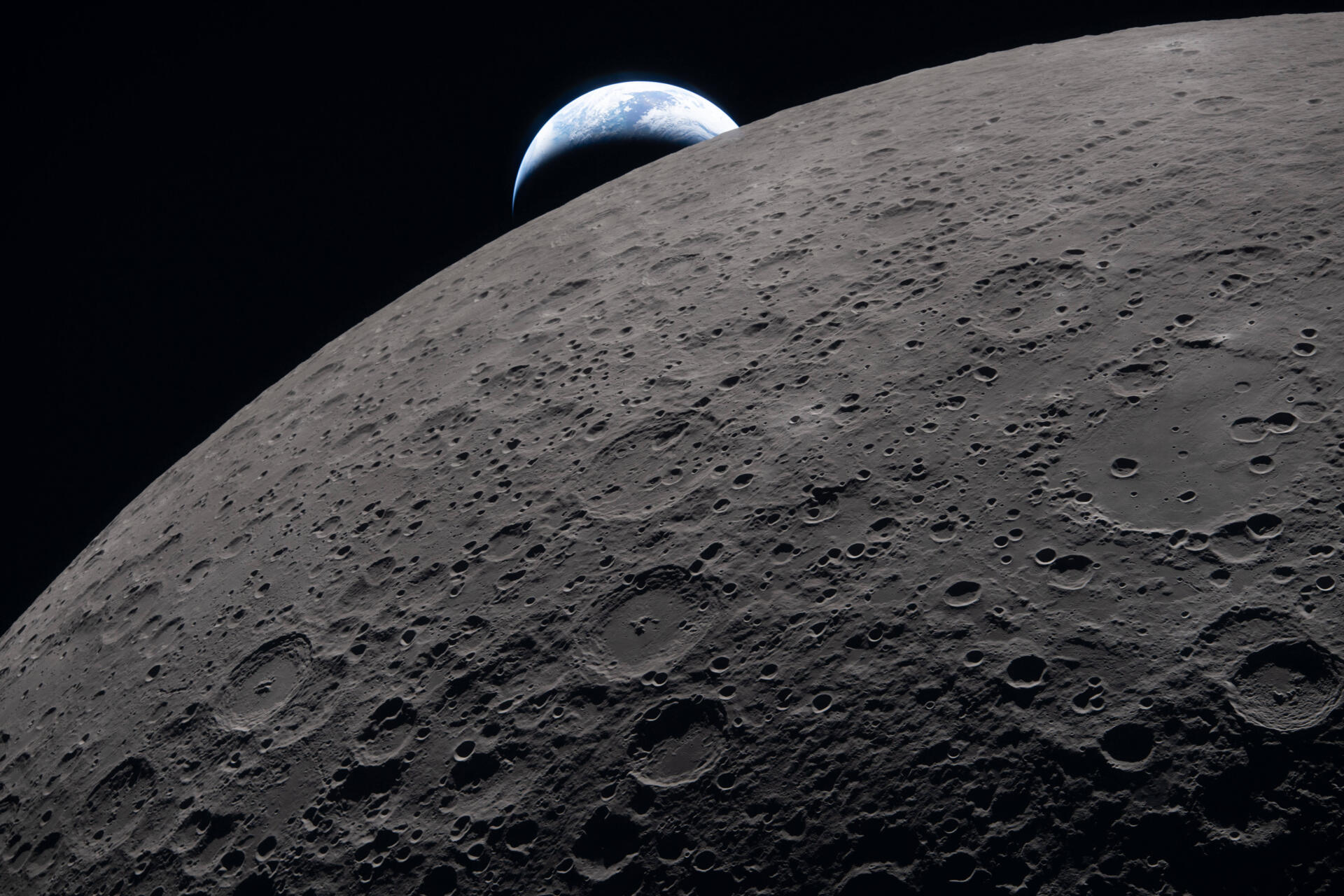 In this image provided by NASA, the Artemis II crew captured this view as the Earth sets behind the Moon during a lunar flyby, Monday, April 6, 2026. (NASA via AP)