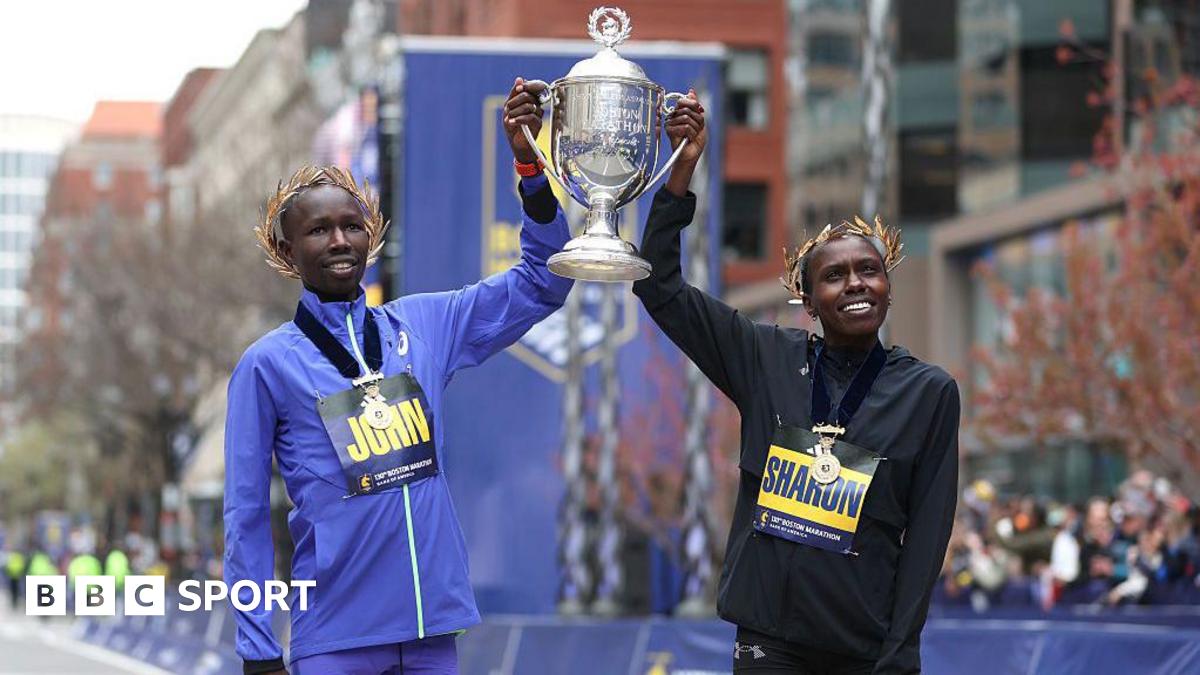 John Korir and Sharon Lokedi hold up the Boston Marathon trophy