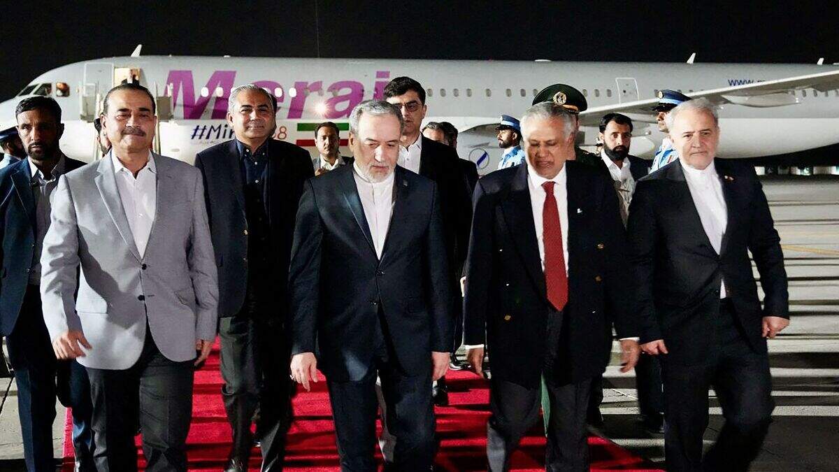 This handout photo released by the Iranian foreign ministry shows Pakistan Foreign Minister Ishaq Dar (left) greeting his Iranian counterpart Abbas Araghchi upon his arrival in Islamabad on 24 April