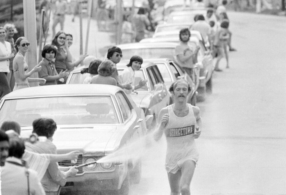 Jack Fultz, 27, of Georgetown University, is sprayed with a hose as he runs through Wellesley, during the 80th annual Boston Marathon on April 19, 1976. (AP file photo)