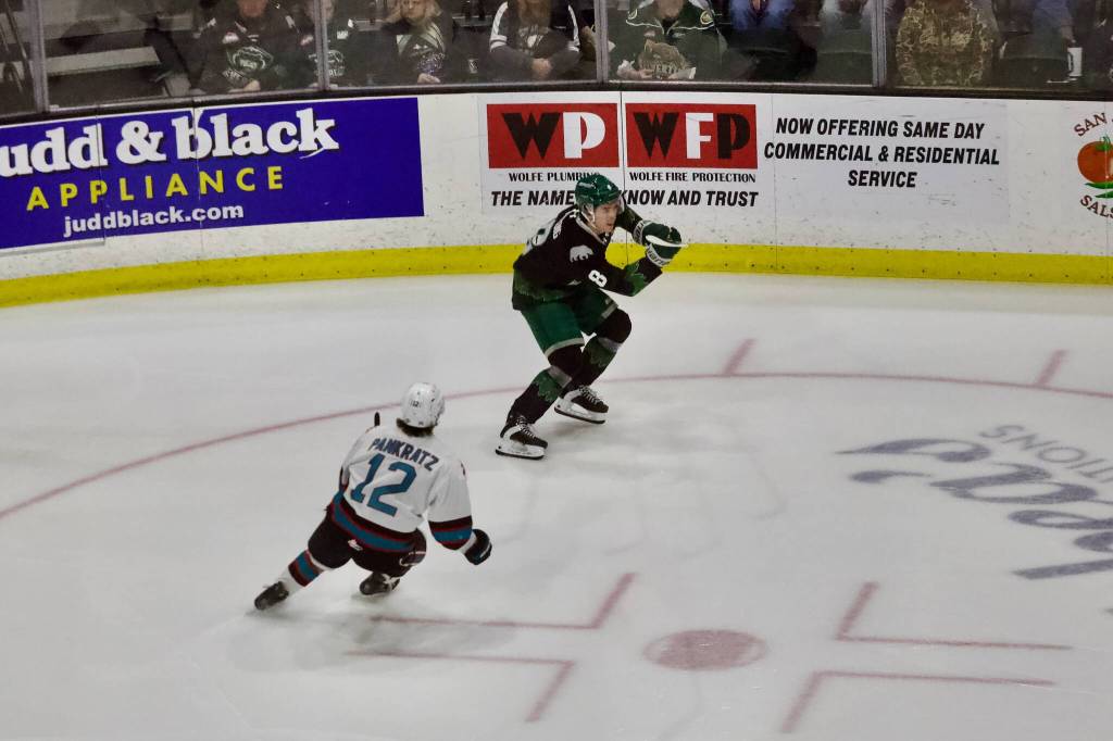 Silvertips defenseman Kayd Ruedig clears the puck out of the defensive zone as Rockets forward Connor Pankratz (12) pursues him during Everetts 4-1 win against Kelowna in Game 1 of the WHL Western Conference semifinals at Angel of the Winds Arena on April 10, 2026. (Joe Pohoryles / The Herald)