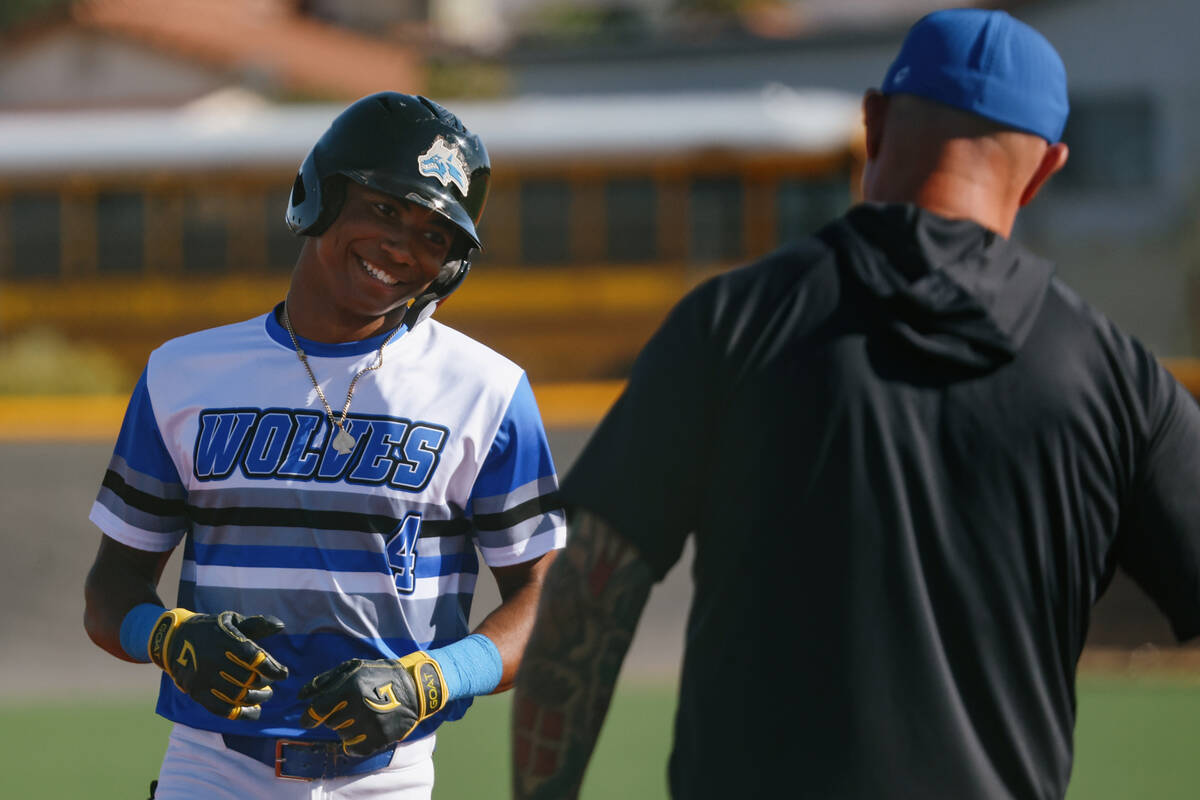 Basic’s Ace Sapp (4) grins as he rounds third base after hitting a home run during the b ...
