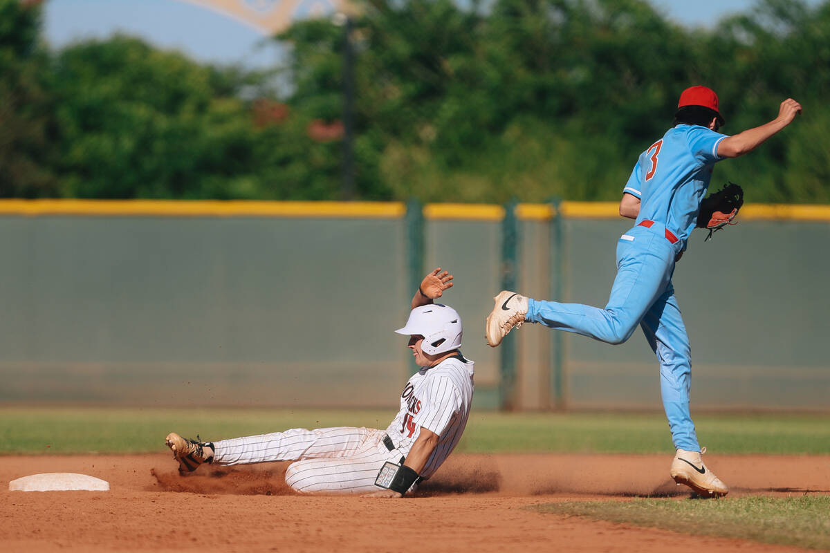 Desert Oasis infielder Brock Zobrist (14) slides into second base as Liberty’s Cole Neil ...