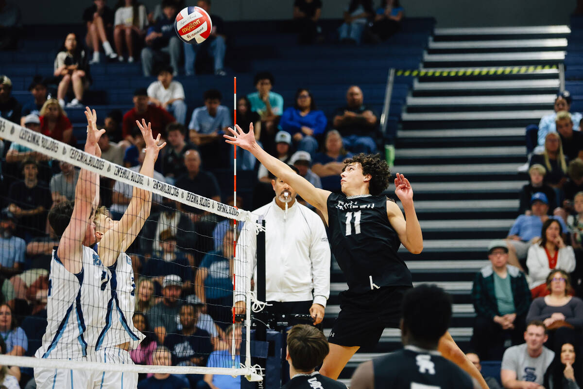Shadow Ridge opposite hitter Mateo Salomon (11) sends the ball back over the net in a high scho ...