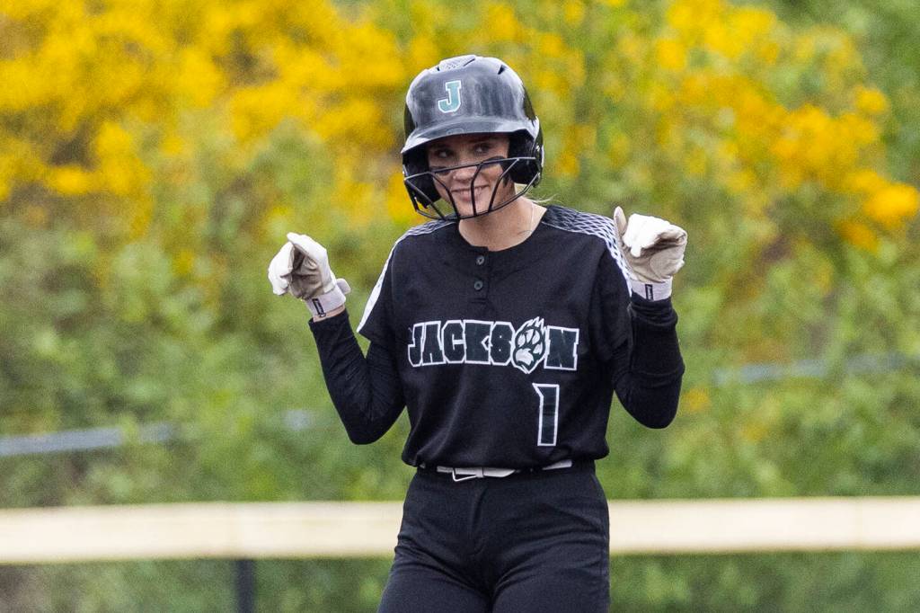 Jackson’s Mia Ediger puts her arms up after making it to second base during the 4A District 1 game against Lake Stevens on Friday, May 16, 2025 in Everett, Washington. (Olivia Vanni / The Herald)