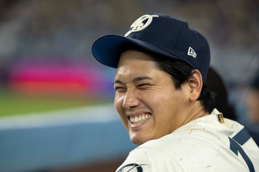 Los Angeles Dodgers' Shohei Ohtani smiles during the ninth inning of a baseball game against the Texas Rangers in Los Angeles, Saturday, April 11, 2026. (AP Photo/Kyusung Gong)