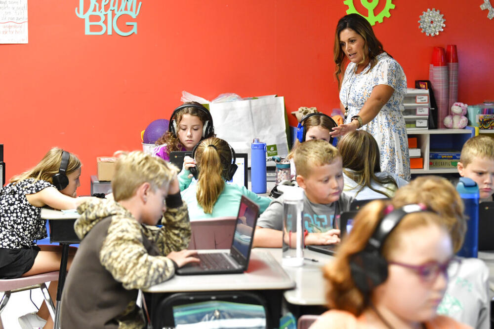 Angela Pike watches her fourth grade students at Lakewood Elementary School in Cecilia, Ky., as they use their laptops to participate in an emotional check-in at the start of the school day, Thursday, Aug. 11, 2022.  (AP Photo/Timothy D. Easley)