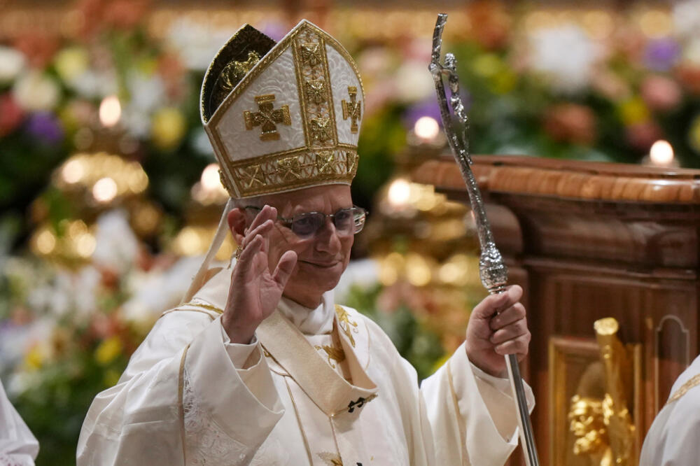 Pope Leo XIV waves after leading the Easter Vigil inside St. Peter's Basilica at The Vatican, Saturday, April 4, 2026. (AP Photo/Andrew Medichini)
