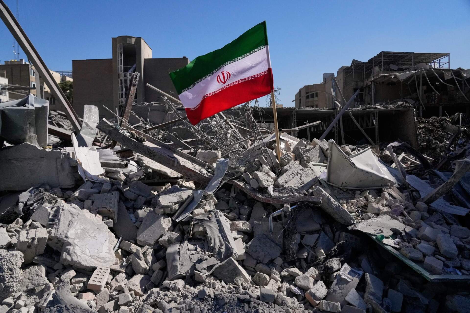 An Iranian flag is placed among the ruins of a police station struck Monday during the U.S.–Israeli military campaign in Tehran, Iran, Tuesday, March 3, 2026. (Vahid Salemi/AP)
