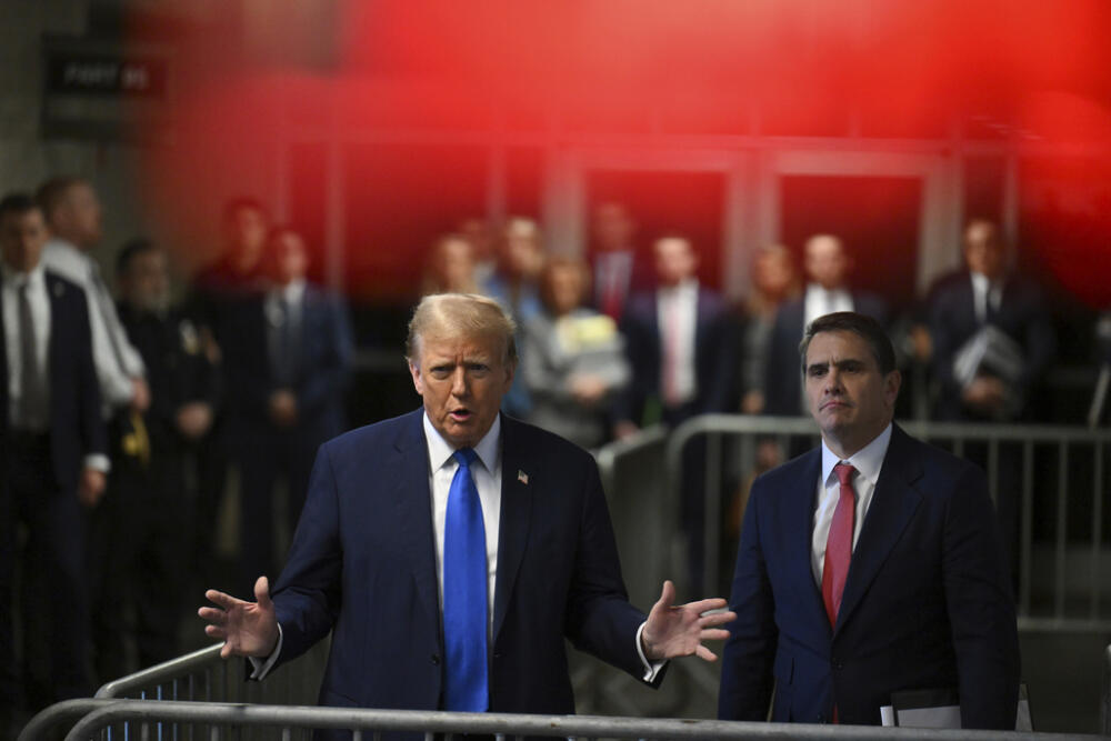 Former U.S. President and Republican presidential candidate Donald Trump speaks to the media, as his attorney, Todd Blanche, right, listens, as his trial continues at Manhattan criminal court in New York, on Monday, April 22, 2024.  (Angela Weiss/Pool Photo via AP)