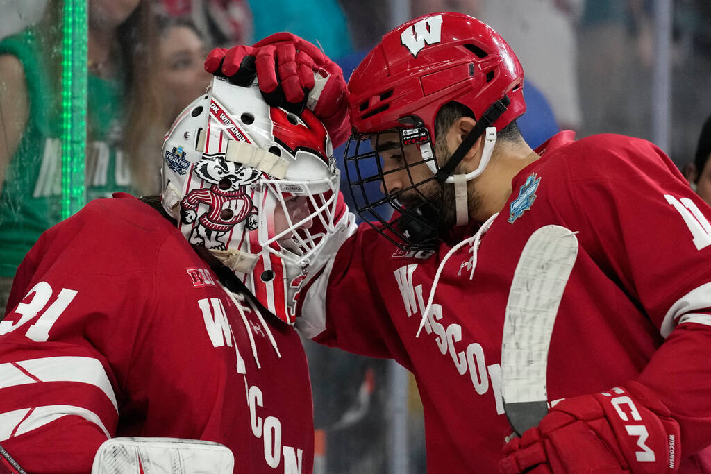 Wisconsin goaltender Daniel Hauser (31) and Wisconsin forward Simon Tassy (11) celebrate after ...