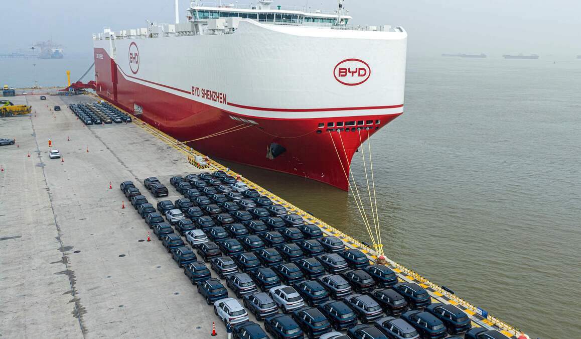 An aerial photo shows BYD’s Shenzhen car carrier docked to load cars for export in the port of Suzhou, in China’s eastern Jiangsu province on April 17, 2026. (Photo by CN-STR / AFP) / China OUT