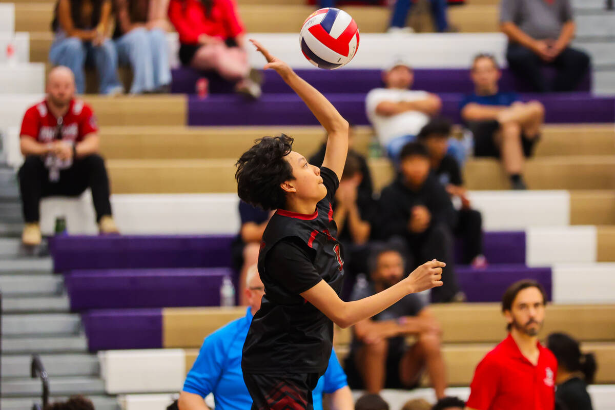 Desert Oasis outside hitter Trevor Labao sets the ball during a class 4A boys volleyball state ...