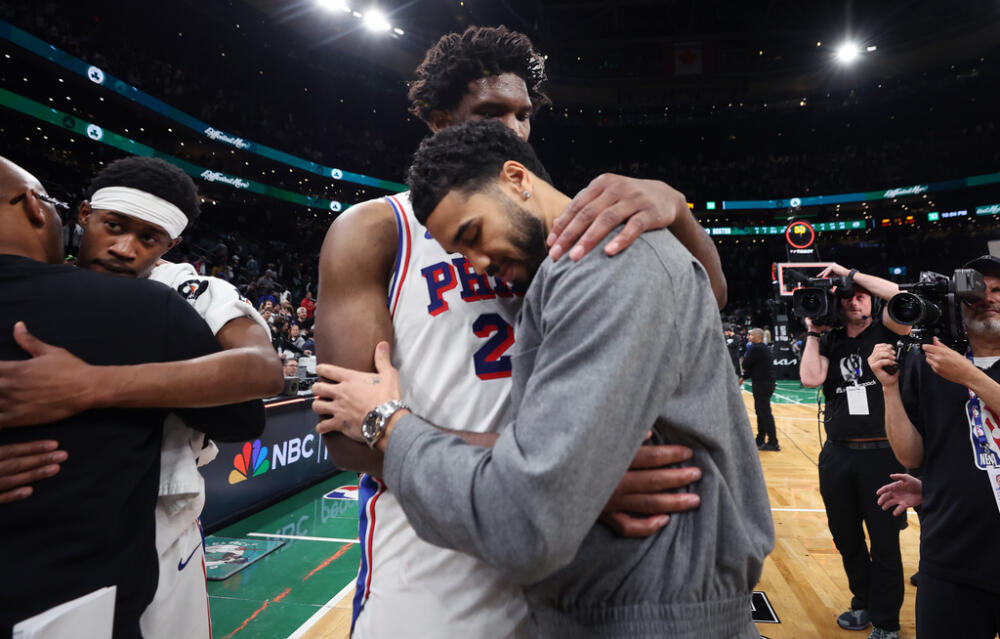 Boston Celtics' Jayson Tatum (right) and Philadelphia 76ers' Joel Embiid (left) embrace following Philadelphia's victory in Game 7 in a first-round NBA basketball playoffs series, Saturday, May 2, 2026 in Boston. (AP Photo/Jim Davis)