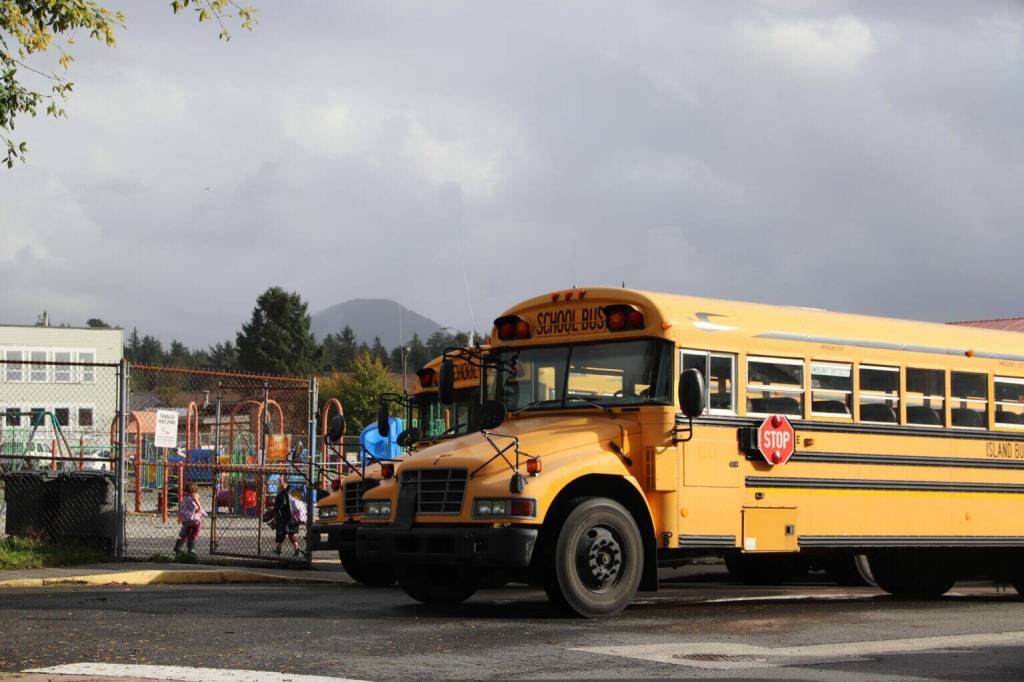School buses park outside the playground of Xóots Elementary School in Sitka on Oct. 6, 2025 (Photo by Corinne Smith/Alaska Beacon)