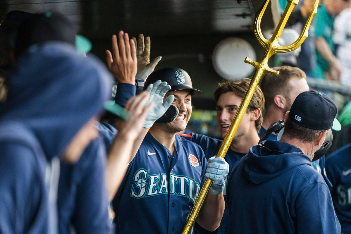 Seattle Mariners' Dominic Canzone, center, celebrates after hitting a home run during the ...