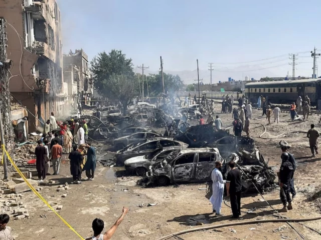 people and police officers gather after a blast near a railway track in quetta pakistan may 24 2026 picture taken with a mobile phone reuters stringer