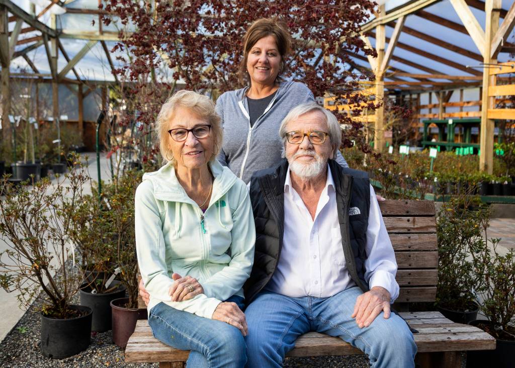 Liesa Postema, center, with her parents John and Marijke Postema, owners of Flower World on Wednesday, Dec. 31, 2025 in Snohomish, Washington. (Olivia Vanni / The Herald)