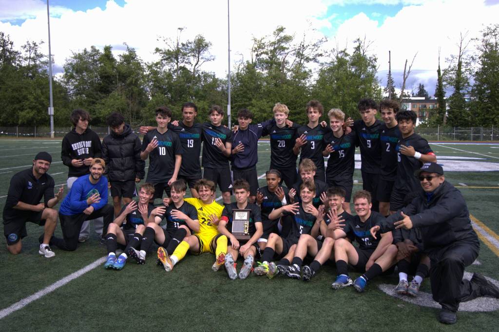 The Shorewood boys soccer team poses with their District 1 3A Tournament trophy after beating Shorecrest 2-0 on Saturday, May 16, 2026 at Shoreline Stadium in Shoreline. (Qasim Ali / The Herald)