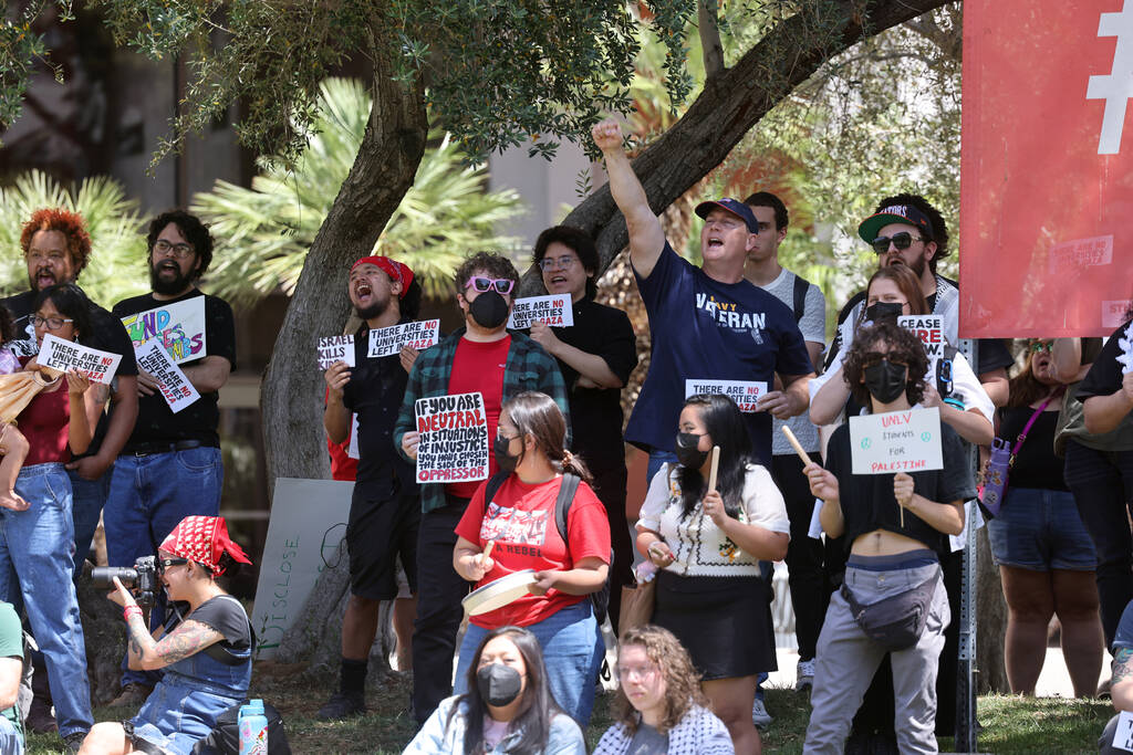 People, including Navy veteran James McCabe listen to a speaker during a rally organized by Stu ...