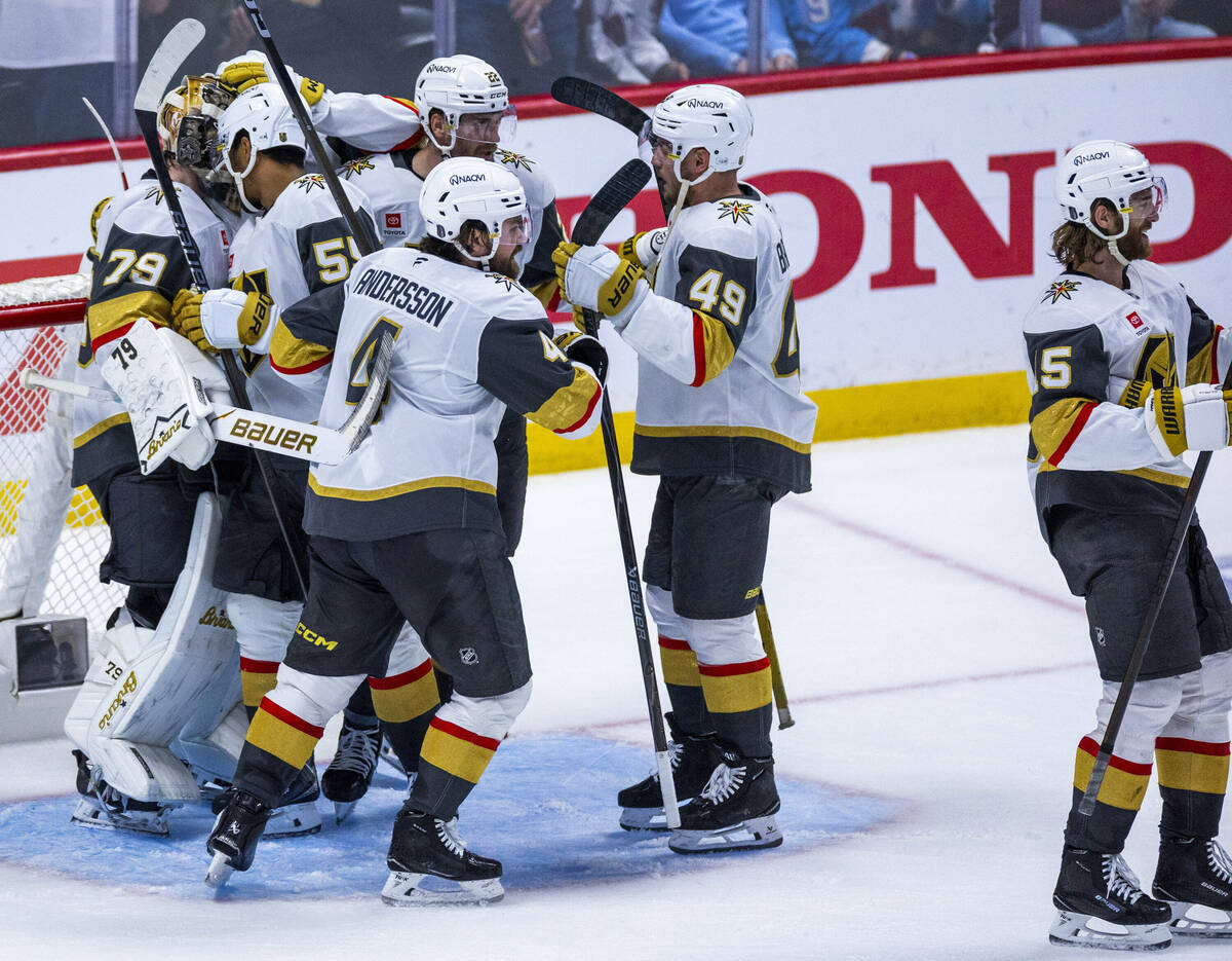 Golden Knights goaltender Carter Hart (79) and teammates celebrate their win over the Colorado ...