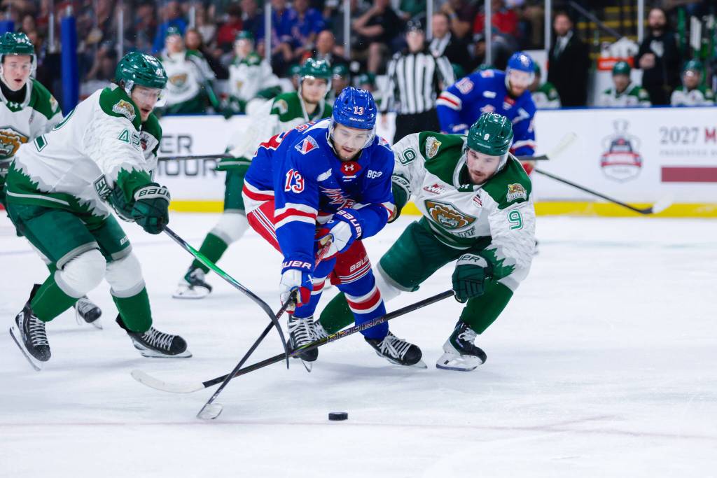 Rangers forward Haeden Ellis (center) tries to keep the puck away from Silvertips defensemen Landon DuPont (right) and Brek Liske (left) during Kitchener’s 6-2 win against Everett in the Memorial Cup round-robin at Prospera Place on May 25, 2026. (Photo courtesy Steve Dunsmoor / CHL)
