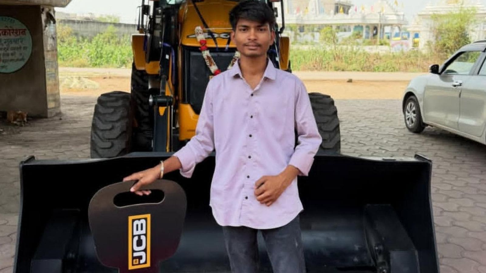 Ayush Kashyap, the deceased, standing in front of his new JCB. Express photo