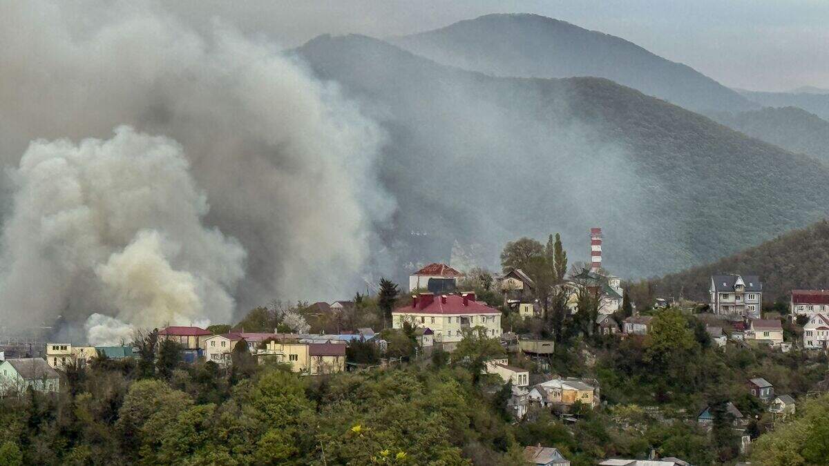 Smoke rises above buildings following a recent drone attack on the Tuapse oil refinery in Tuapse, Krasnodar region on April 29, 2026, amid the ongoing Russian-Ukrainian conflict. (Photo by AFP)