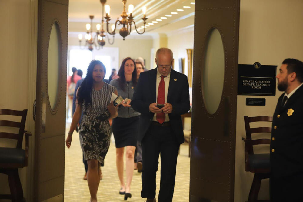 Sens. Lydia Edwards, Kelly Dooner and Peter Durant (from left) exit the Senate chamber on May 28, 2026 following a Senate session. (Ella Adams/SHNS)