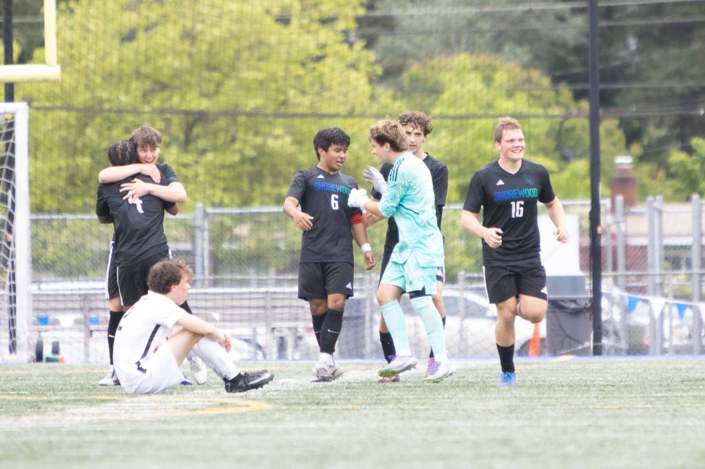The Shorewood boys soccer team, including midfielder Isak Medhaug (6), embraces each other after beating Eastside Catholic 3-2 in a state quarterfinal game on Saturday, May 23, 2026 at Shoreline Stadium in Shoreline. (Qasim Ali / The Herald)