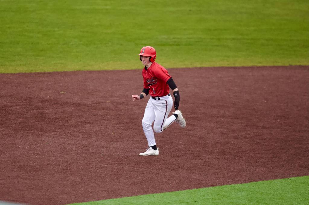 Snohomish senior Chase Clark runs between second and third base during the Panthers’ 6-5 win against Kamiak in their season-opener at Kamiak High School on March 11, 2026. (Joe Pohoryles / The Herald)