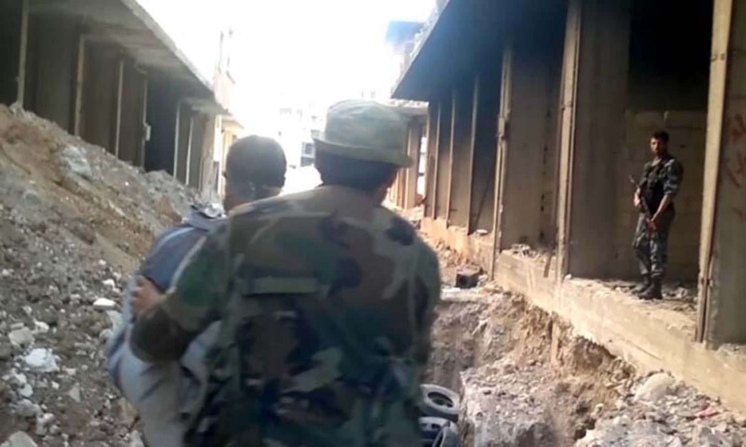 A screenshot from the video recording of the Tadamon massacre shows a man being led by Syrian regime intelligence members before he was killed. (The Guardian)
