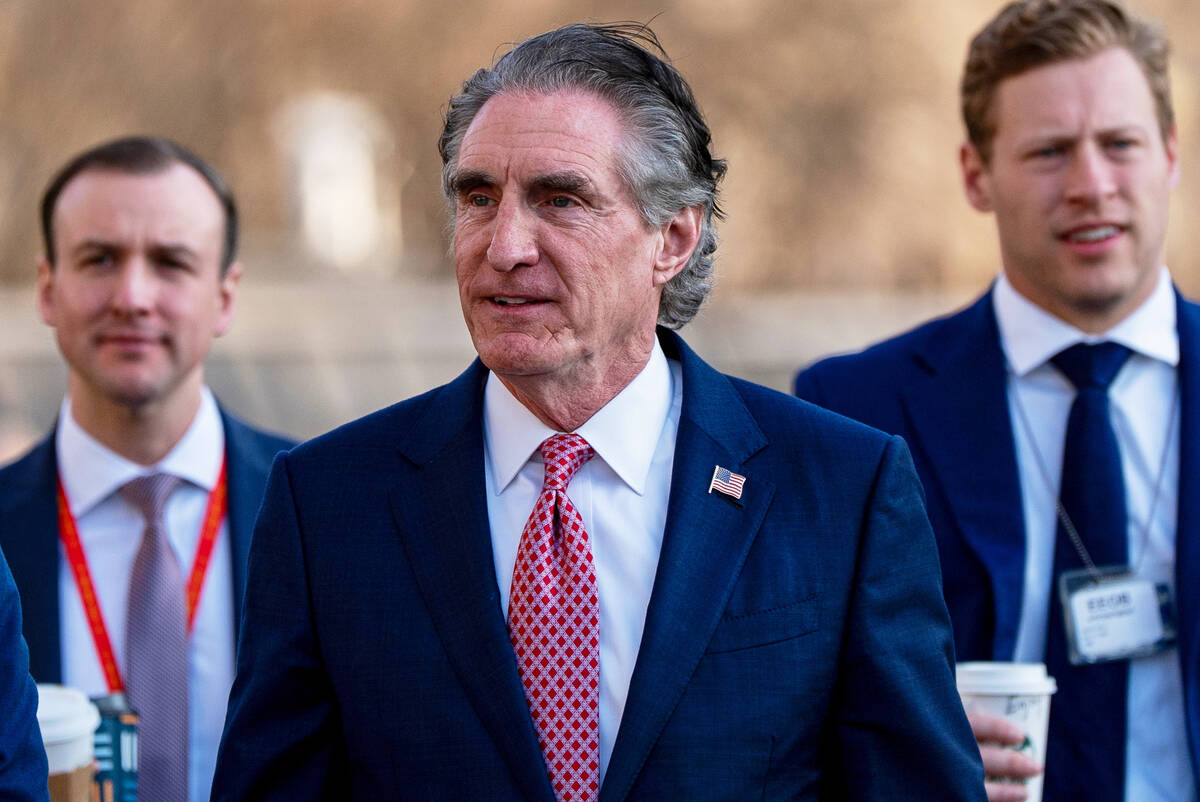 Interior Secretary Doug Burgum, center, is seen at the White House, March 11, 2026, in Washingt ...