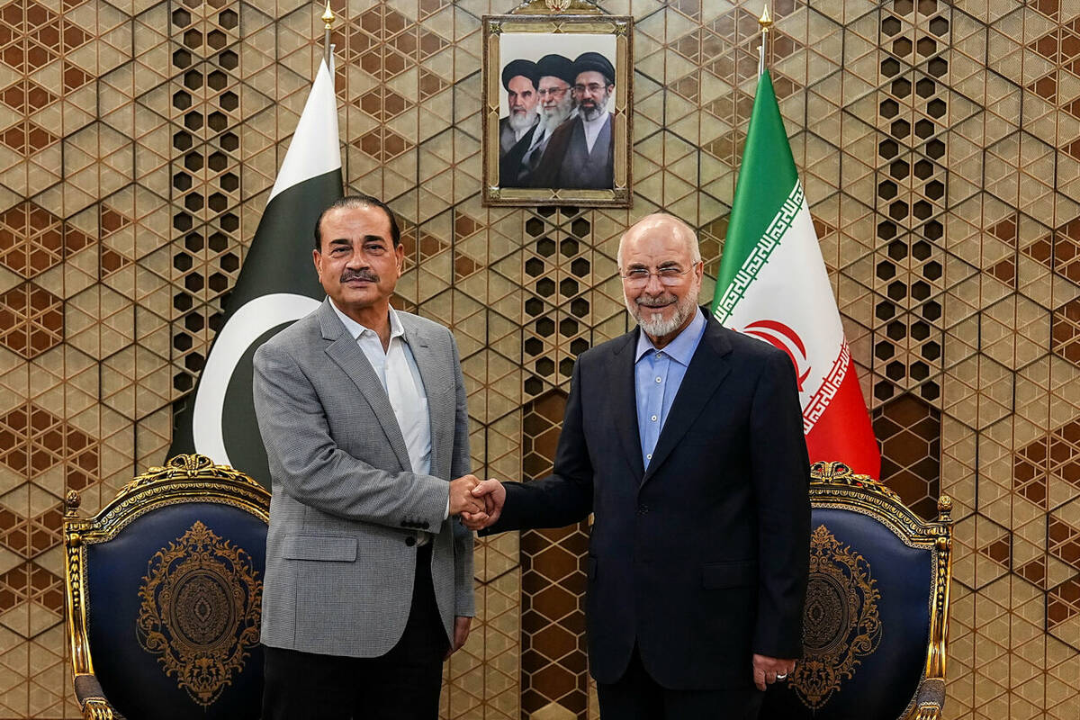 Iran's Parliament Speaker Mohammad Bagher Qalibaf, right, shakes hands with Pakistan' ...