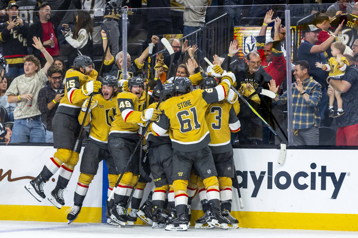 Golden Knights players celebrate their double overtime win against the Utah Mammoth during thei ...
