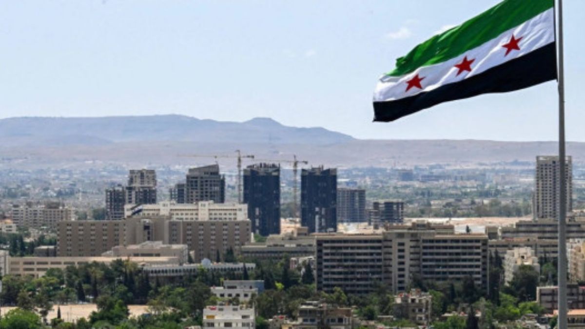 The Syrian flag flying over Umayyad Park, formerly Tishreen Park, in Damascus. (AFP)