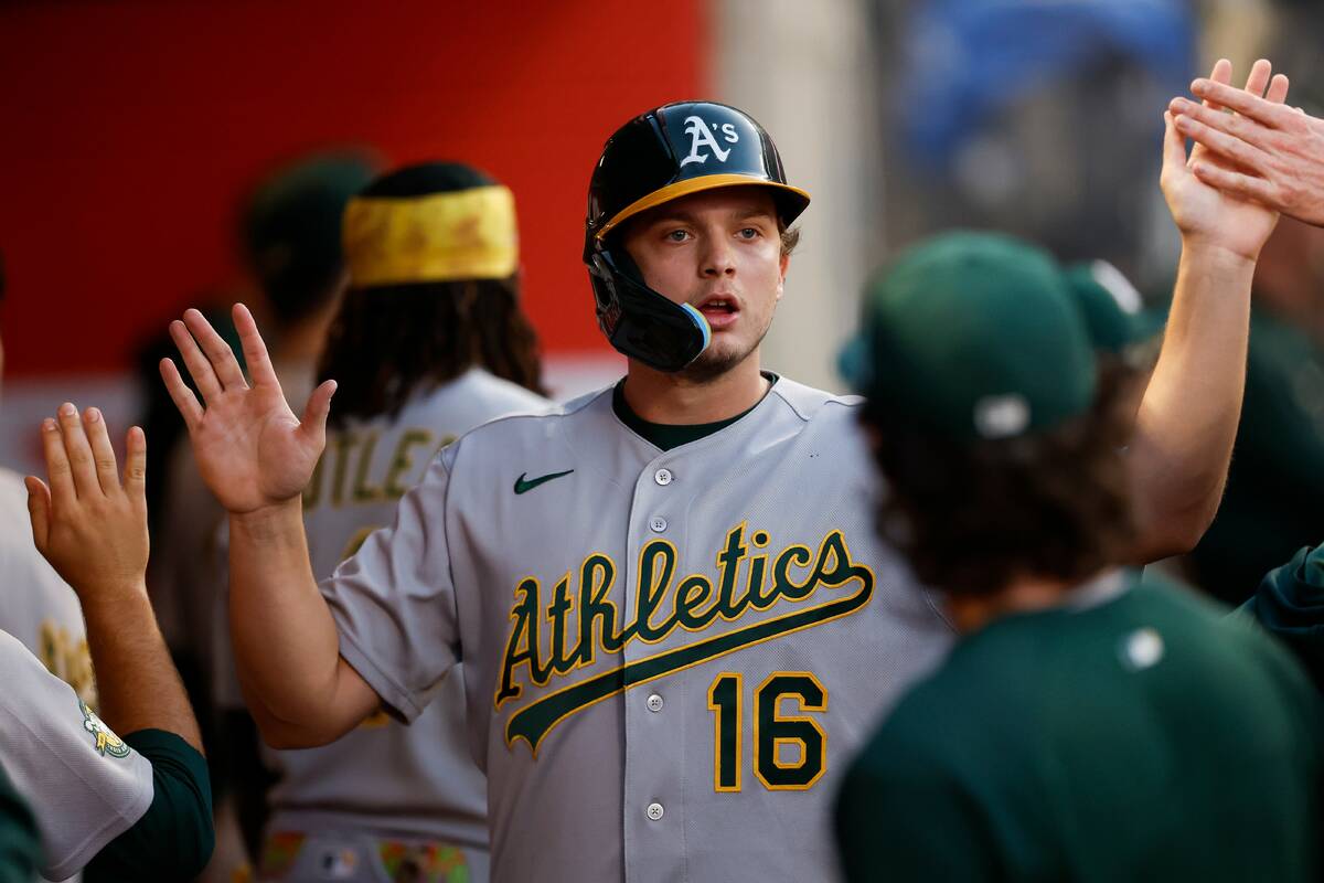 Athletics' Nick Kurtz (16) is greeted by teammates after scoring on a single by Shea Lange ...