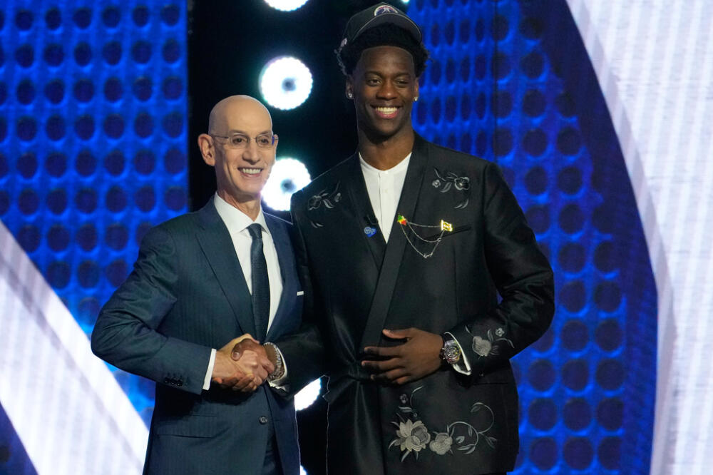 AJ Dybantsa poses for a photo with NBA commissioner Adam Silver after being selected by the Washington Wizards as the first pick in the first round of the NBA basketball draft in New York. (Yuki Iwamura/AP)