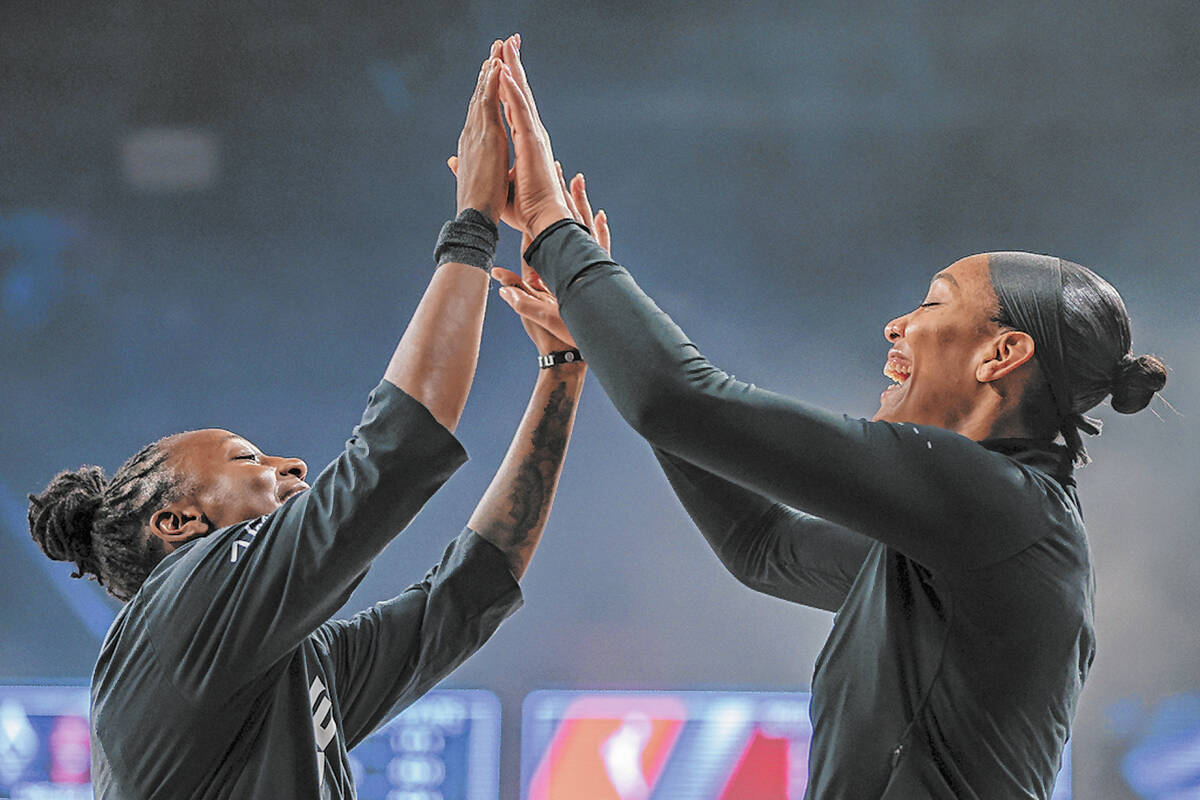 Aces guard Jewell Loyd (24) and Aces center A'ja Wilson (22) do a special handshake togeth ...
