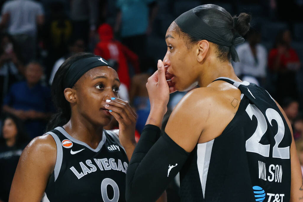 Aces center A'ja Wilson (22) and Aces guard Jackie Young (0) confer with each other after ...