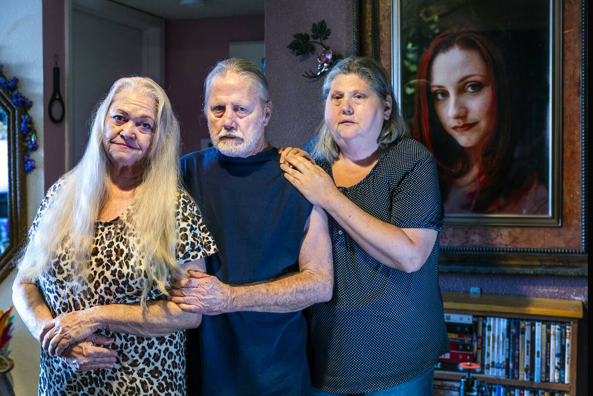 Laura, Vanessa and Richard Gudenkauf with a portrait of Bernadette Gudenkauf from 2006 hanging ...