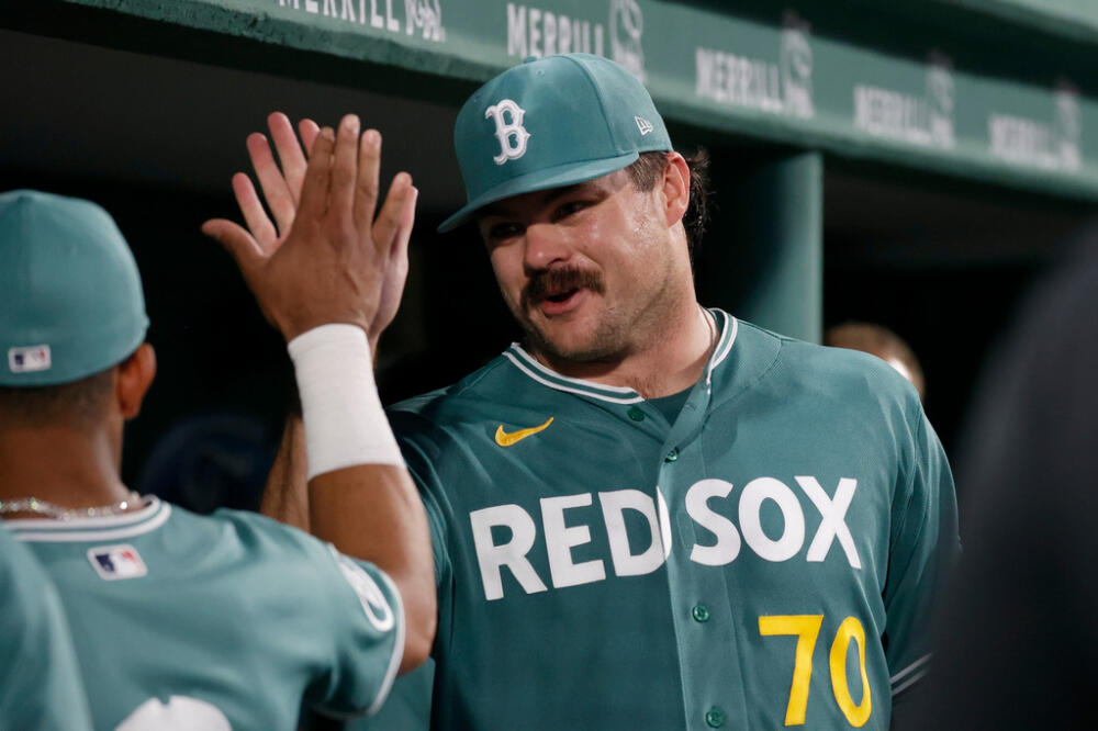 Boston Red Sox starting pitcher Payton Tolle (70) is congratulated by teammates in the dugout after the seventh inning of a baseball game against the New York Yankees, Friday, June 26, 2026, in Boston. (AP Photo/Mary Schwalm)
